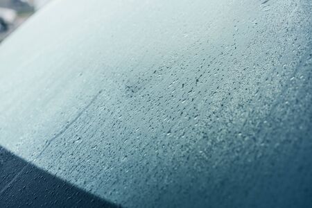 Raindrops on the hood of the car. Close-up.の写真素材