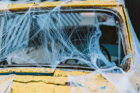 Old retro yellow taxi decorated with cobwebsの写真素材