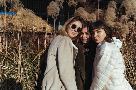 Carefree women posing on the street background.の写真素材