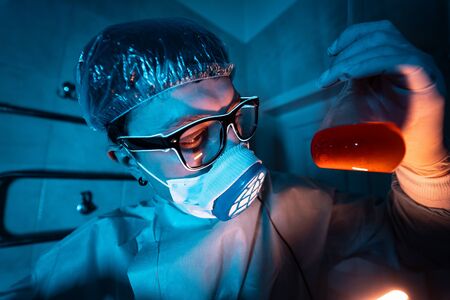 Young male researcher carrying out scientific experiment.の写真素材