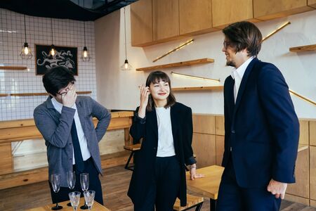 Group of business people in a meeting standing grouped in a office