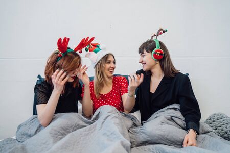 Smiling Female Models Holding Wine Glasses And Enjoying Pajamas Party.の写真素材