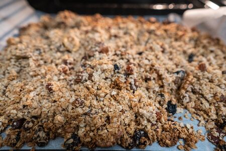 granola to cook in an oven. concept of simple ingredients for healthy breakfastの写真素材