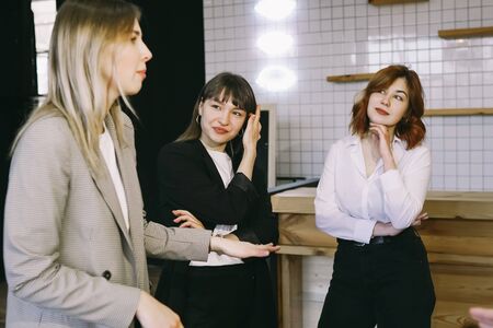 Group of business people in a meeting standing grouped in a office