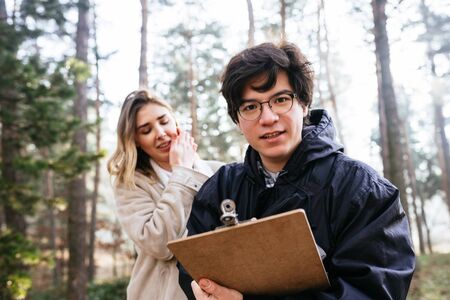 Scientists are studying plant species and inspect trees in the forest.