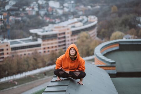 Woman practicing yoga on the roof and doing yoga exercises