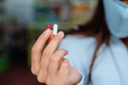 Woman shows pills, vitamins or pills in her hand.の写真素材