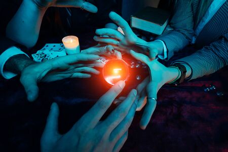 Group of people and woman fortune teller with crystal ballの写真素材