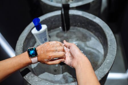 Woman washing hands to protect against the coronavirusの写真素材