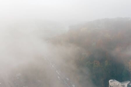 A city covered in fog. City traffic, aerial viewの写真素材