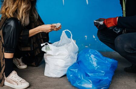 Two young women sorting garbage. Concept of recycling.の写真素材
