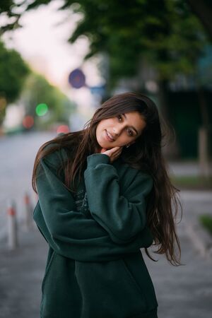 Portrait of cute girl with long hair looks at the camera
