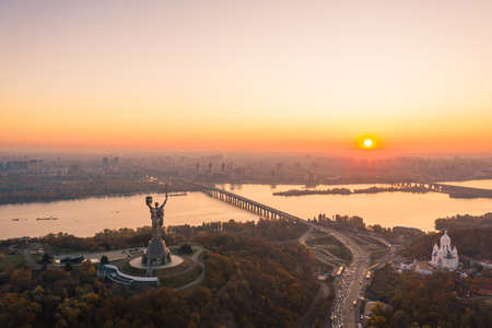 Kiev skyline over beautiful fiery sunset, Ukraine. Monument motherland.