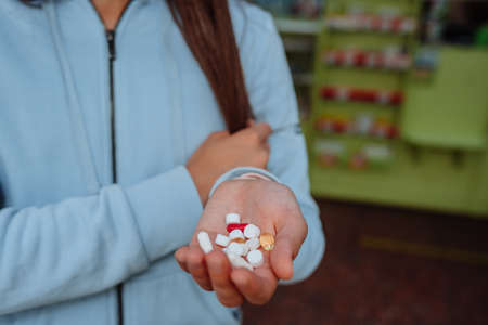 Coronavirus. Covid-19. A man or woman takes and shows pills.の写真素材