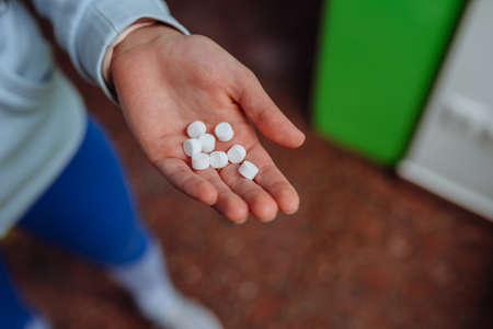 Coronavirus. Covid-19. A man or woman takes and shows pills.の写真素材