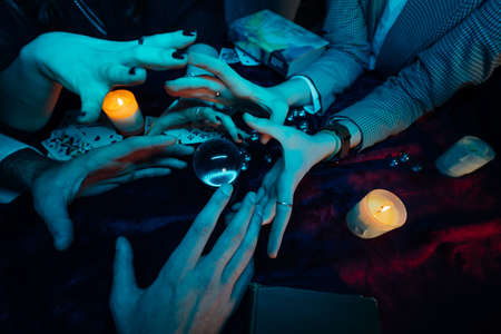 Group of people and woman fortune teller with crystal ball