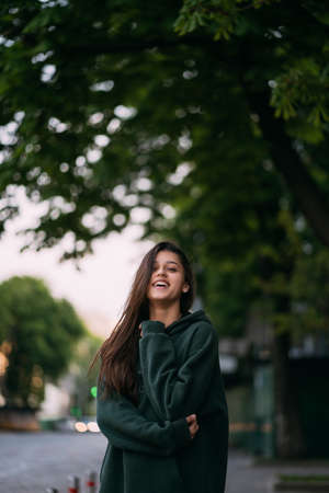 Portrait of cute girl with long hair looks at the cameraの写真素材
