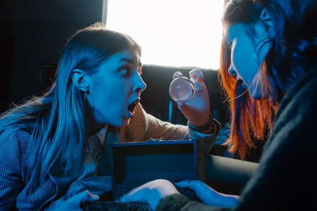 Woman and woman fortune teller with crystal ball