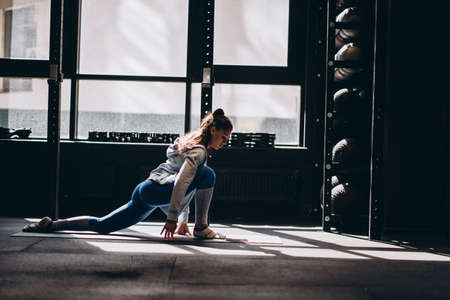 Portrait of attractive young woman doing yoga or pilates exerciseの写真素材