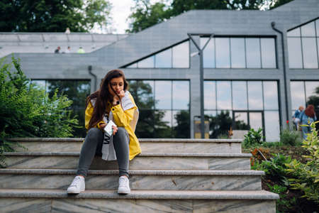 Portrait of cute beautiful young woman having fun and posing outdoors.の写真素材