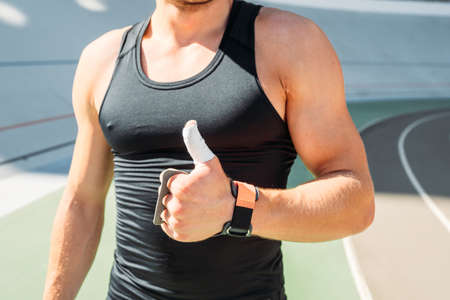 cropped view of sexy bodybuilder showing thumbs up