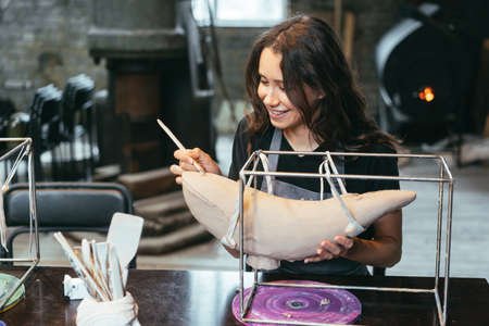 Portrait of a young woman enjoying a favorite job in the workshop.