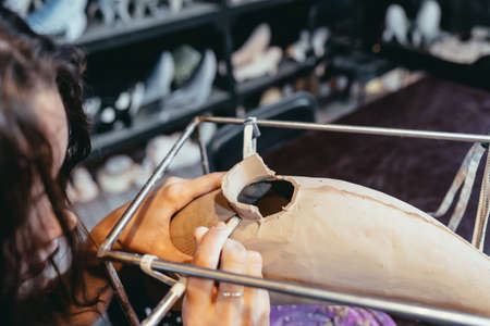 Portrait of young woman enjoying favorite job in workshop.の写真素材