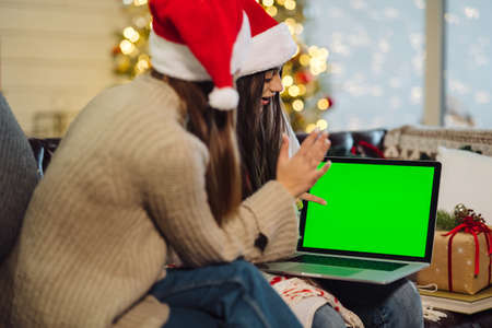 Two girls communicate via the Internet with friends.の写真素材