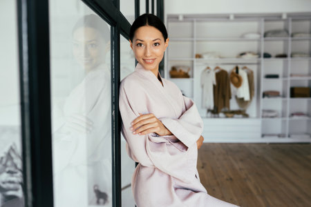 Portrait of a beautiful healthy woman in bathrobe indoorsの写真素材