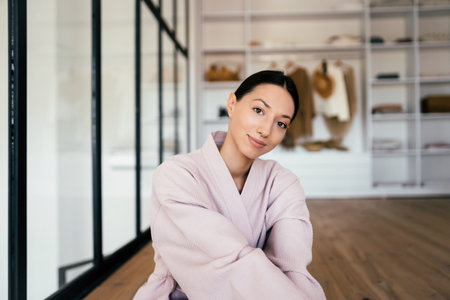 Portrait of a beautiful healthy woman in bathrobe indoorsの写真素材