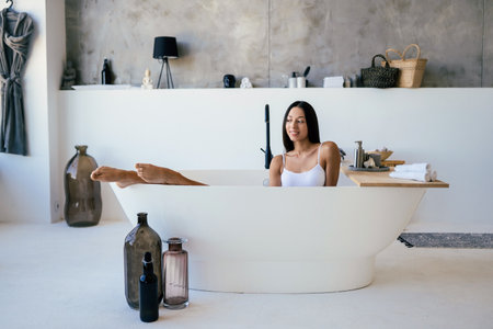 Attractive woman in lingerie posing in the bathの写真素材