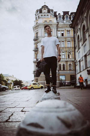 Guy stand on the city street, look camera and around