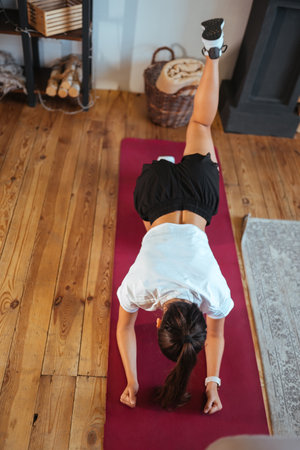 Beautiful woman practising yoga at sunny morning.
