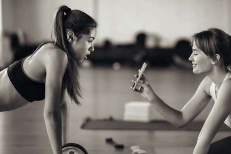 Young woman practicing yoga, is engaged with the teacher online.