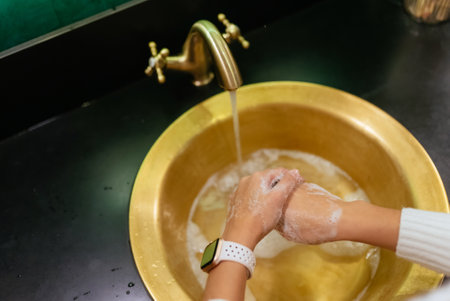 Close up photo of woman washes her hands with soap and water.の写真素材