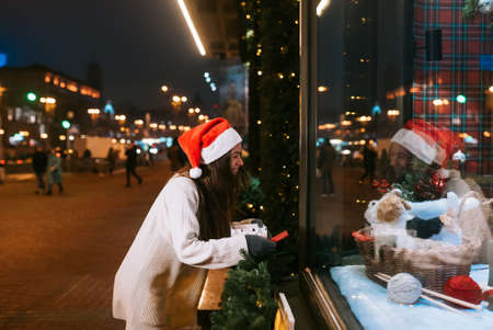 Night street portrait of young beautiful woman acting thrilled.の写真素材