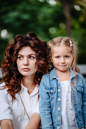Lovely young mom and daughter in sunny day, happy familyの写真素材
