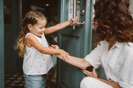 Young mother and cute little daughter walking down the streetの写真素材