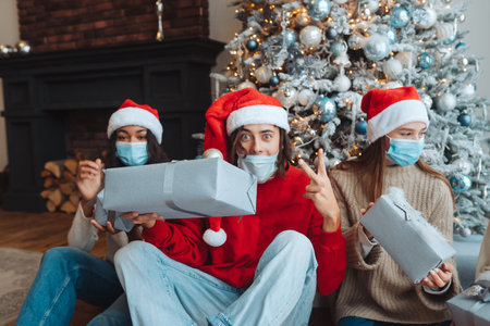 Multiethnic group of friends in Santa hats with gifts in hands.の写真素材