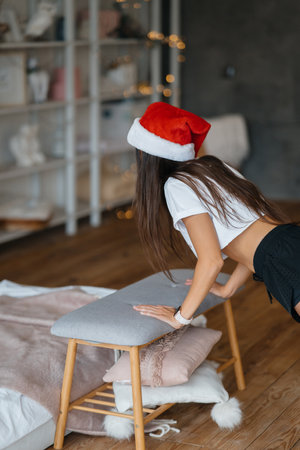 Young woman in santa hat practicing sport gymnastic exercisesの写真素材