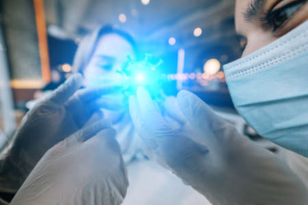 Scientist virologist holding model of new Coronavirus or COVID-19