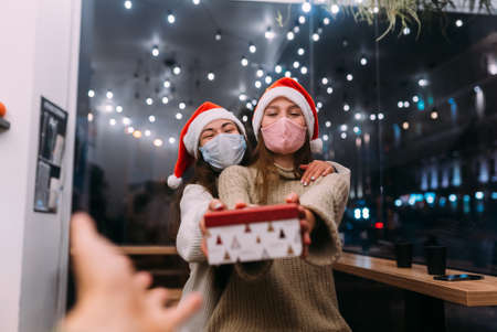 Young beautiful women, give gift box in camera at cafe.の写真素材
