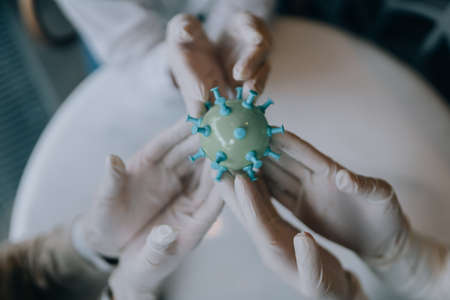 Scientist virologist holding model of new Coronavirus or COVID-19の写真素材