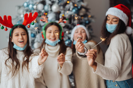Multi-ethnic young people celebrating New year eve holding sparklersの写真素材
