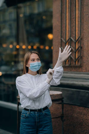 Young woman with face mask in the streetの写真素材