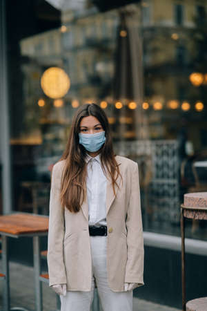 Young woman with face mask in the streetの写真素材
