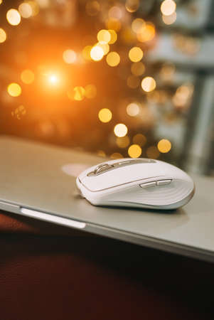 Modern wireless computer mouse on wooden table