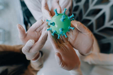 Scientist virologist holding model of new Coronavirus or COVID-19の写真素材