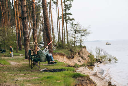 Couple Relaxing in a Hammock Overlooking the Water