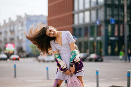 Portrait of pretty young woman, having fun at the street.